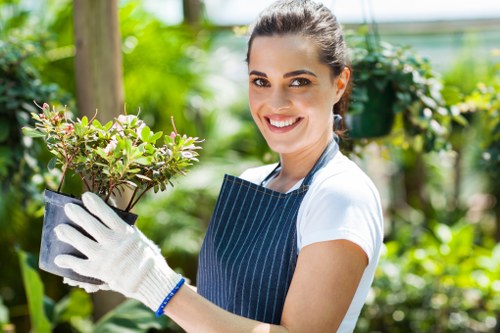 Gardener in Highgate arranging plants with clear labels for screen-reader compatibility